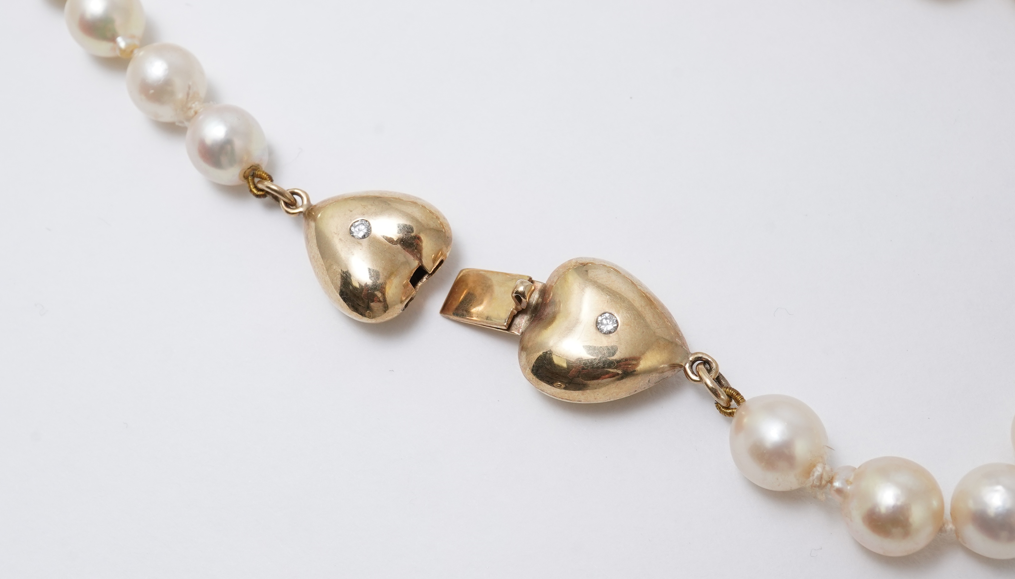 A cultured pearl, gold and diamond necklace